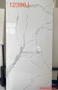 a large white marble slab with red numbers on it