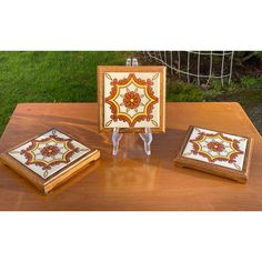 three decorative wooden boxes sitting on top of a table