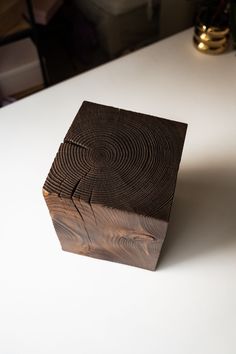 a wooden box sitting on top of a white table