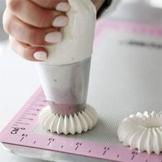 a person is using a small brush to make something white