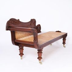 an antique wooden bed frame with caned footrests and carved wood headboard