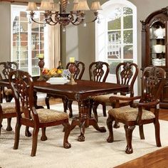 a dining room table with chairs and a china cabinet