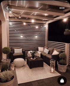 an outdoor living area with couches, chairs and potted plants on the floor