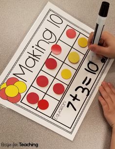 a child's hand is writing on a piece of paper that has been made to look like a sud puzzle