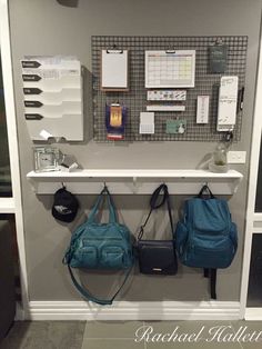 two purses are hanging on the wall next to a shelf with several other purses