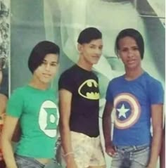 three young men standing next to each other in front of a batman t - shirt