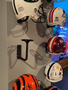 football helmets are hanging on the wall