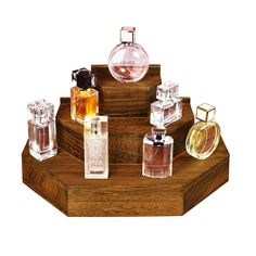 an assortment of perfume bottles on a wooden stand