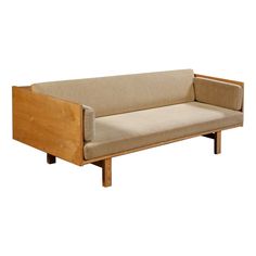 a wooden couch sitting on top of a white floor