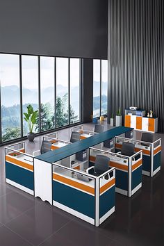 an office cubicle with multiple desks and chairs in front of large windows overlooking the mountains