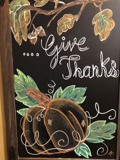 a chalkboard sign with the words give thanks written on it