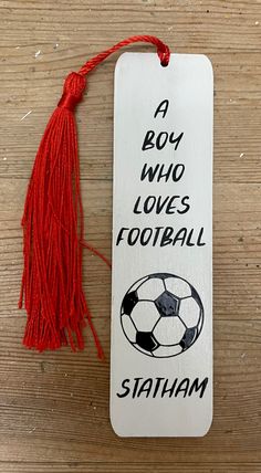 a bookmark that says boy who loves football with a soccer ball and tassel