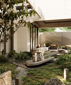 an outdoor living area with plants and rocks