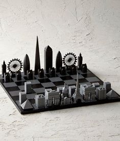 a black and white chess board with an image of the london skyline on it's side