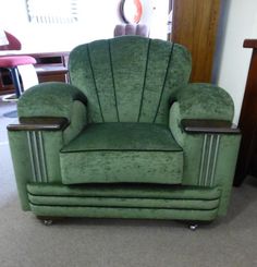 a green chair sitting on top of a carpeted floor