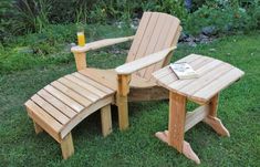 a wooden chair and table sitting in the grass