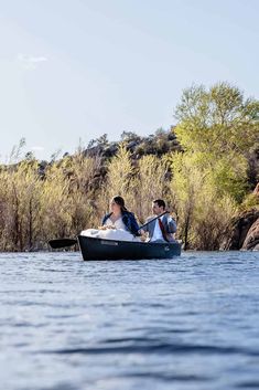 two people in a small boat on the water