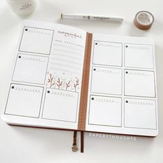 an open planner book sitting on top of a table