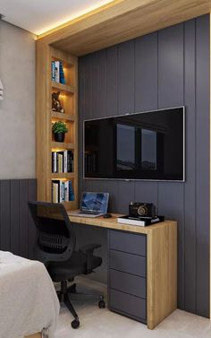 a bedroom with a desk, bookcases and a tv mounted on the wall