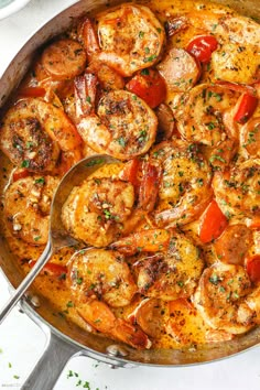 a skillet filled with shrimp and tomatoes