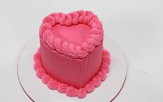 a heart shaped cake sitting on top of a white plate