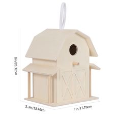 a white birdhouse with a roof and window