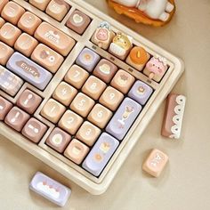 a keyboard that is sitting on a table next to some little toy animals and other items