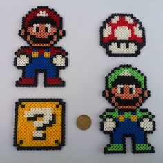 four pixel art magnets with mario and luigi on them