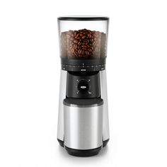 a coffee grinder with beans in it on a white background