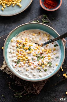 a bowl filled with corn on top of a table