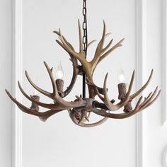 a deer antler chandelier hanging from the ceiling in front of a door