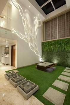 an indoor living room with artificial grass and stone steps