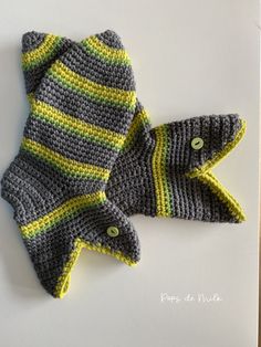 two crocheted mittens sitting next to each other