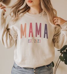 "Make Mother's Day extra special with our custom Mama Established Sweatshirt! This one-of-a-kind top features the word \"Mama\" and the year you became a parent, making it the perfect way to show off your mama status and celebrate your journey. Perfect for all types of moms - whether you're a new mom, stepmom, foster mom, adoptive mom, or any other type of mother - this sweatshirt is sure to bring a smile to your face and warm your heart. So, why wait? Order yours today and let the world know yo Family Sweatshirts, Aunt To Be, Aunt Sweatshirt, Adoptive Mom, New Aunt, Gifts For Your Sister, Foster Mom