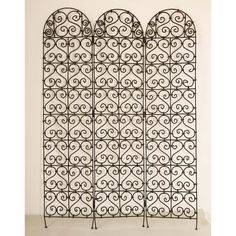 two wrought iron screens are shown against a white wall