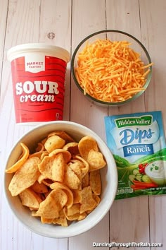 two bowls filled with chips and cheese next to yogurt