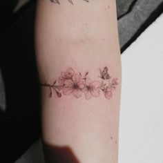 a woman's arm with flowers on it