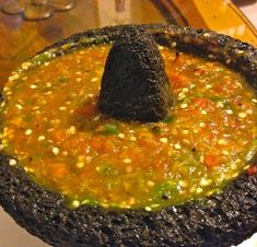 an odd looking food item is sitting on a plate with a black object sticking out of it