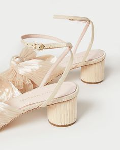 Pleated mid-heel sandal in cream fabric topped with our signature knotted bow. Features a padded footbed with gold stamped logo. Open toe with adjustable buckle ankle strap. 2 inch heel. Pearl Fabric, Mid Heel Sandals, Cream Fabric, Bow Heels, Ivory Pearl, Heeled Sandal, Loeffler Randall, Recycled Rubber, 2 Inch Heels