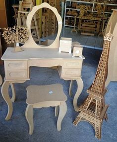 a desk with a mirror, stool and eiffel tower