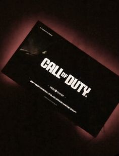 a black box with the words call of duty written on it in white letters, against a dark background