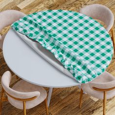 an overhead view of a table with chairs and a green checkered cloth on it