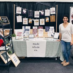 a woman standing next to a table with cards on it