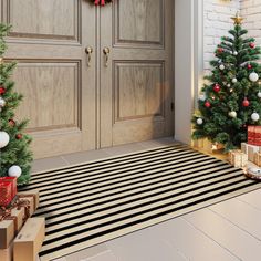 two christmas trees in front of a door with presents on the floor next to it