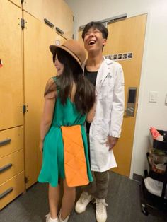 a man and woman standing next to each other in front of lockers with hats on