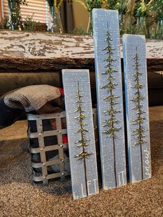 some skis are sitting on the ground next to a basket with pine trees in it