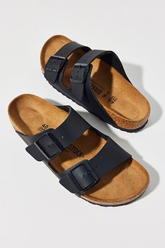 The Arizona is a genuine Birkenstock classic that has long held cult status thanks to its comfort factor. This simple sandal in a two-strap design features an upper made from the skin-friendly, hard-wearing synthetic material Birko-Flor, with an anatomically-shaped cork-latex footbed lined in suede. Features Birkenstock Arizona Birko-Flor Sandals Birkenstock sandals in faux leather Slide sandals with a cork footbed Slip-on sandal style Content + Care Birko-Flor, suede, cork, EVA Spot clean Imported Size + Fit Birkenstock narrow A-B width Fits like a medium B width | Birkenstock Arizona Birko-Flor Sandal in Black, Women's at Urban Outfitters Classic Double Strap Cushioned Footbed Sandals, Classic Footbed Sandals With Double Strap And Adjustable Fit, Classic Sandals With Textured Footbed And Double Strap, Classic Sandals With Textured Double Strap, Classic Double Strap Sandals With Cushioned Footbed, Classic Adjustable Slip-on Footbed Sandals, Sandals Birkenstock, Birkenstock Black, Sandal Style