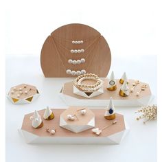 an assortment of jewelry displayed on wooden trays