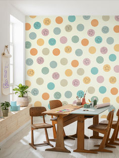 a dining room table with four chairs and a wallpaper