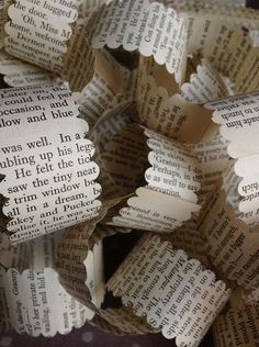 several pieces of folded book paper with words on them